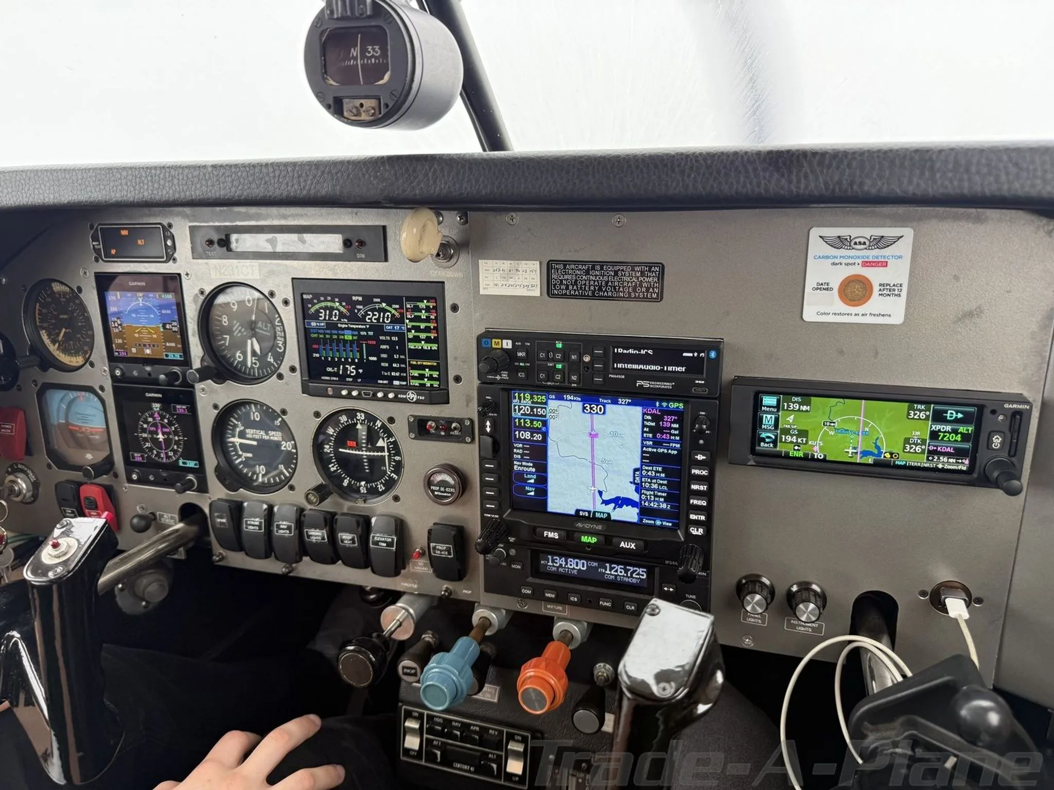 Detailed view of the aircraft's instrument panel featuring modern Garmin avionics and traditional gauges.