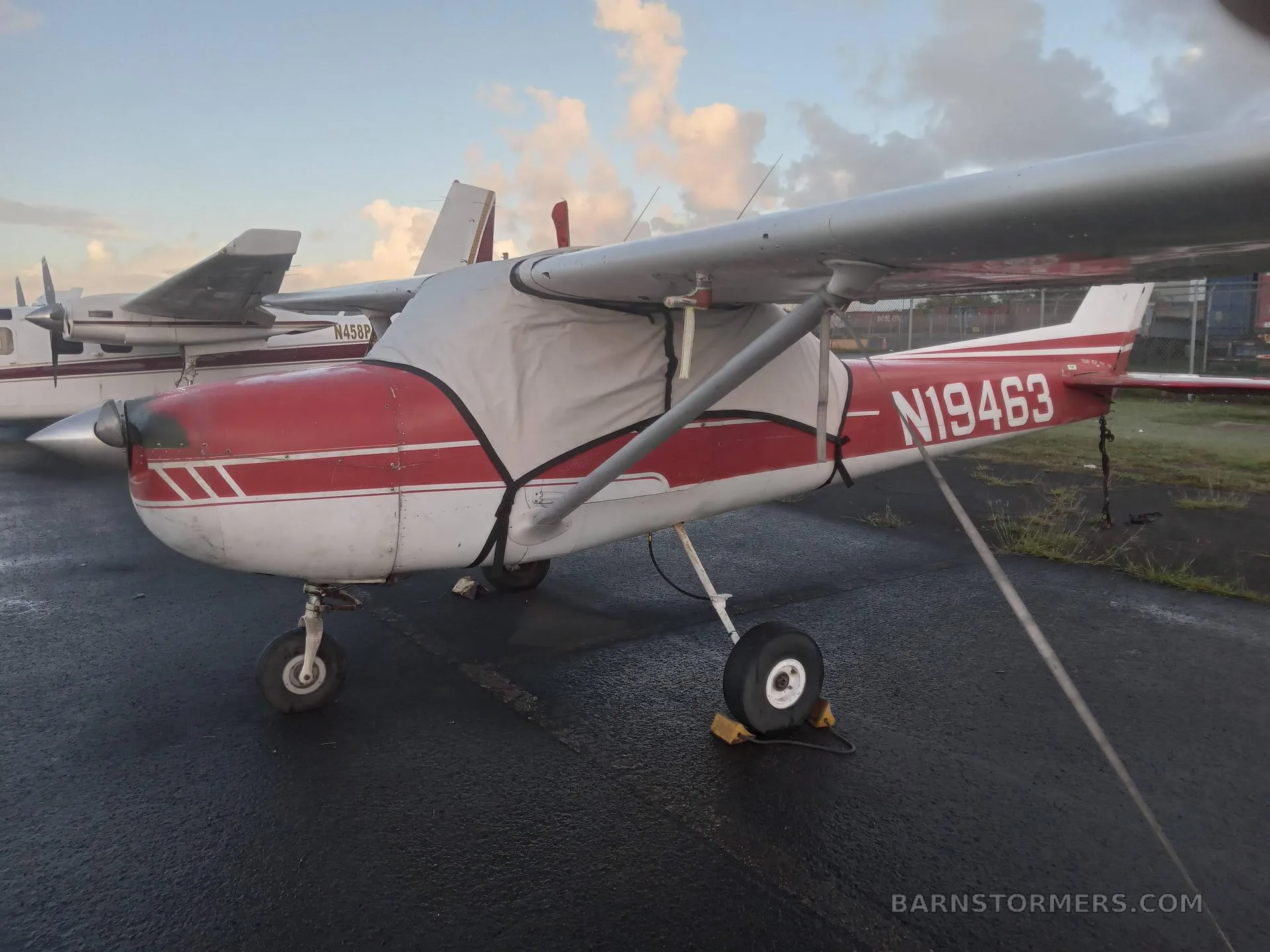 The cockpit of a light aircraft, showing the instrument panel, yokes, and front seats.