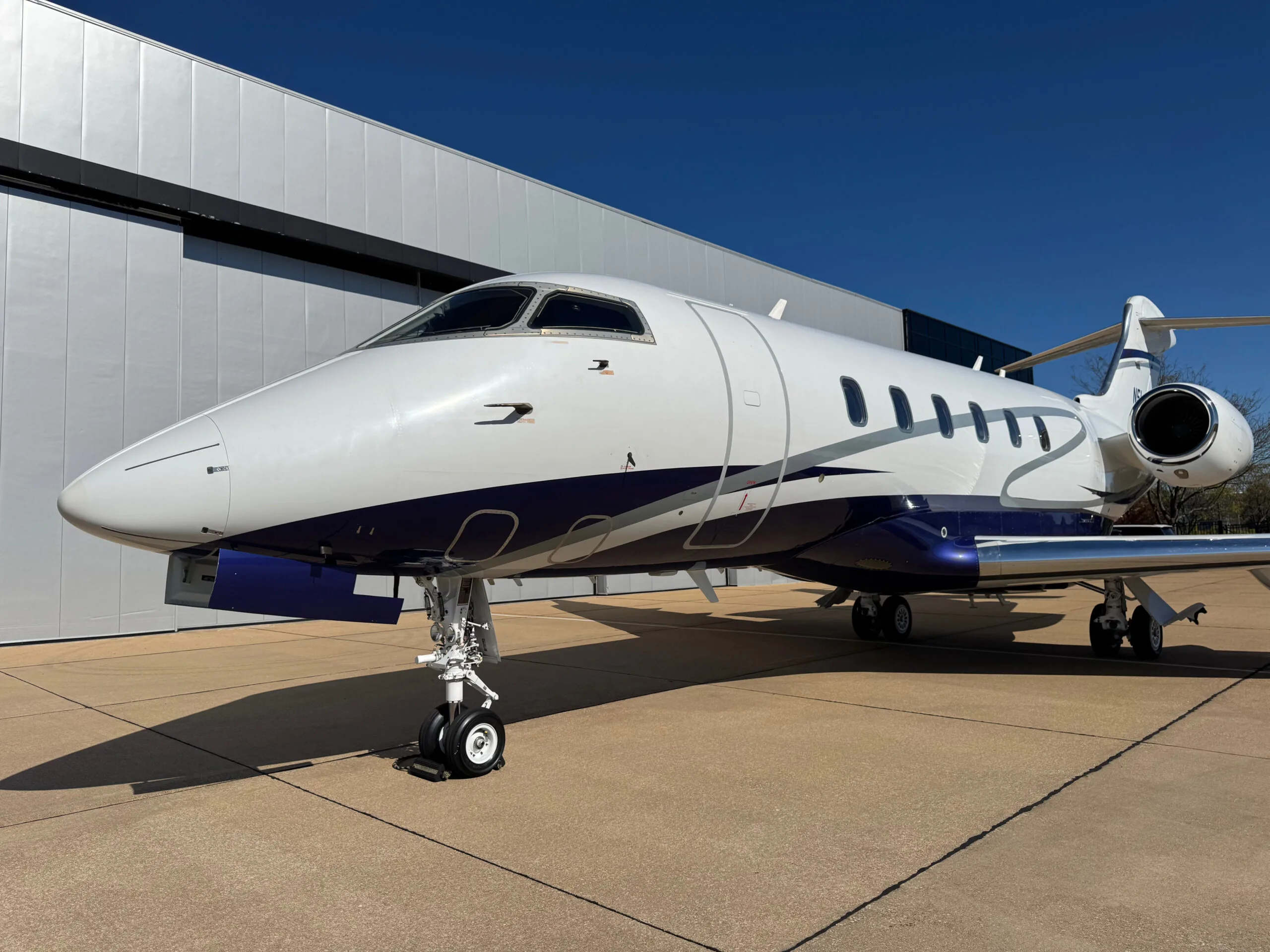 Front view of the N5L business jet, highlighting its nose, cockpit windows, and landing gear.