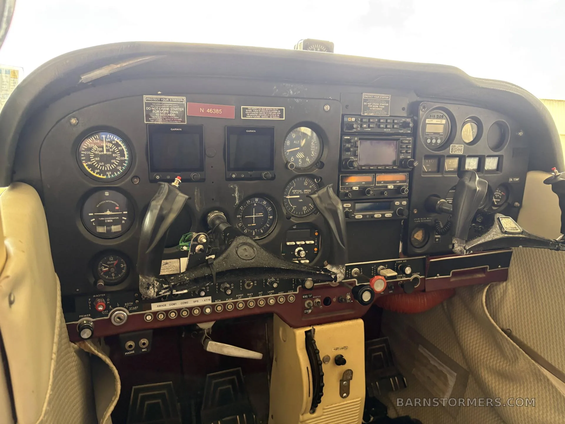 The cockpit instrument panel of a small aircraft, showing various gauges, avionics, and controls.