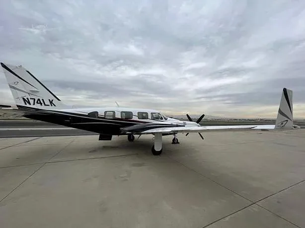 A side view of the 1980 Piper Navajo CR on the tarmac.