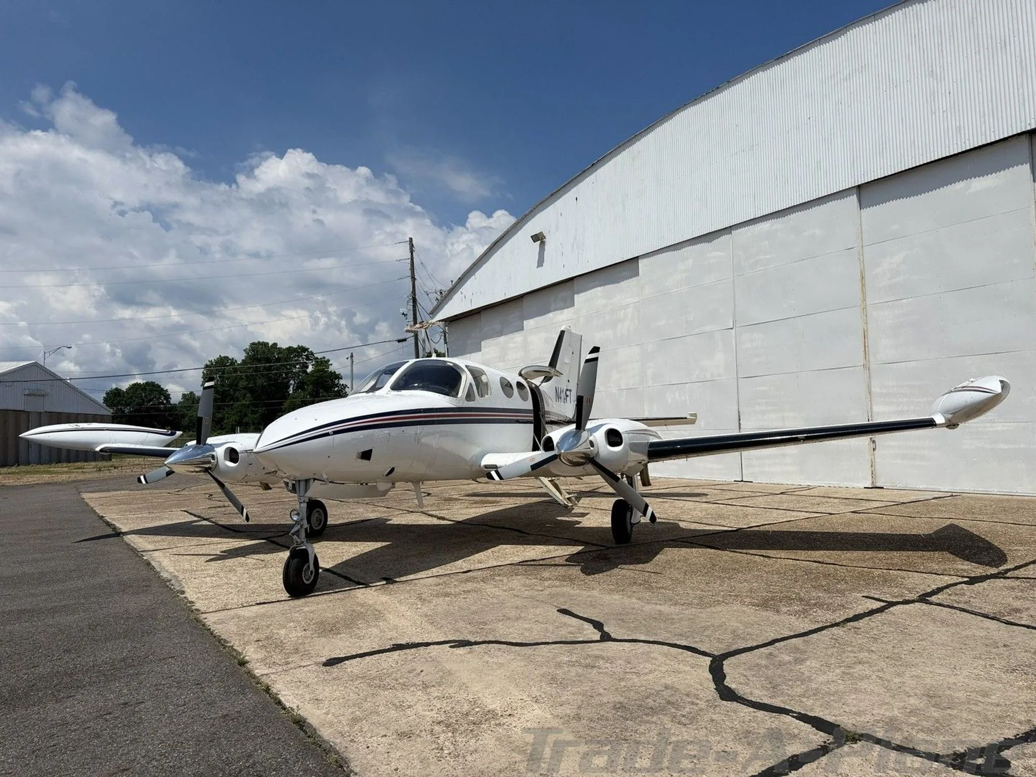 Cessna 414 parked with a clear sky in the background.