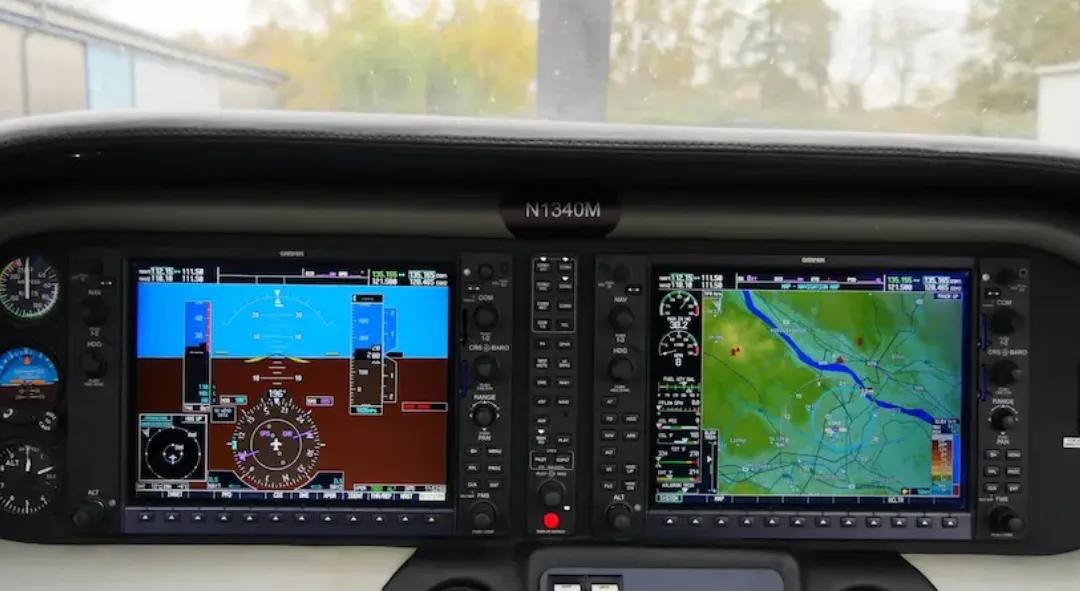 The cockpit of a Columbia 400 aircraft with registration N1340M, showing two large Garmin G1000 displays with flight and navigation information.