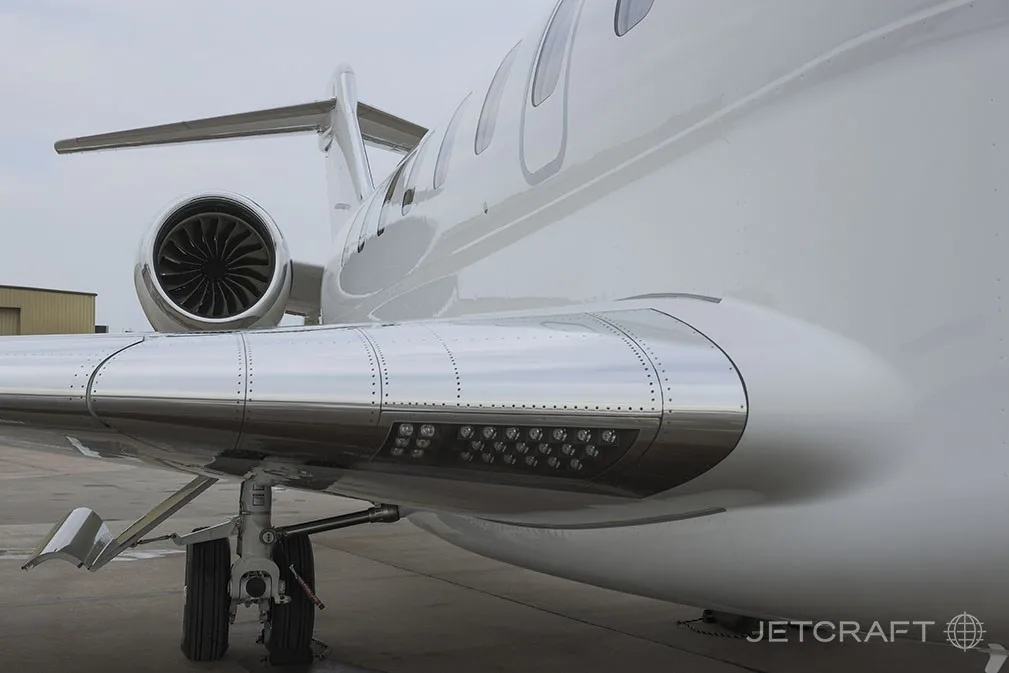 A close-up view of the right wing and engine of a white Bombardier Global 7500 business jet.