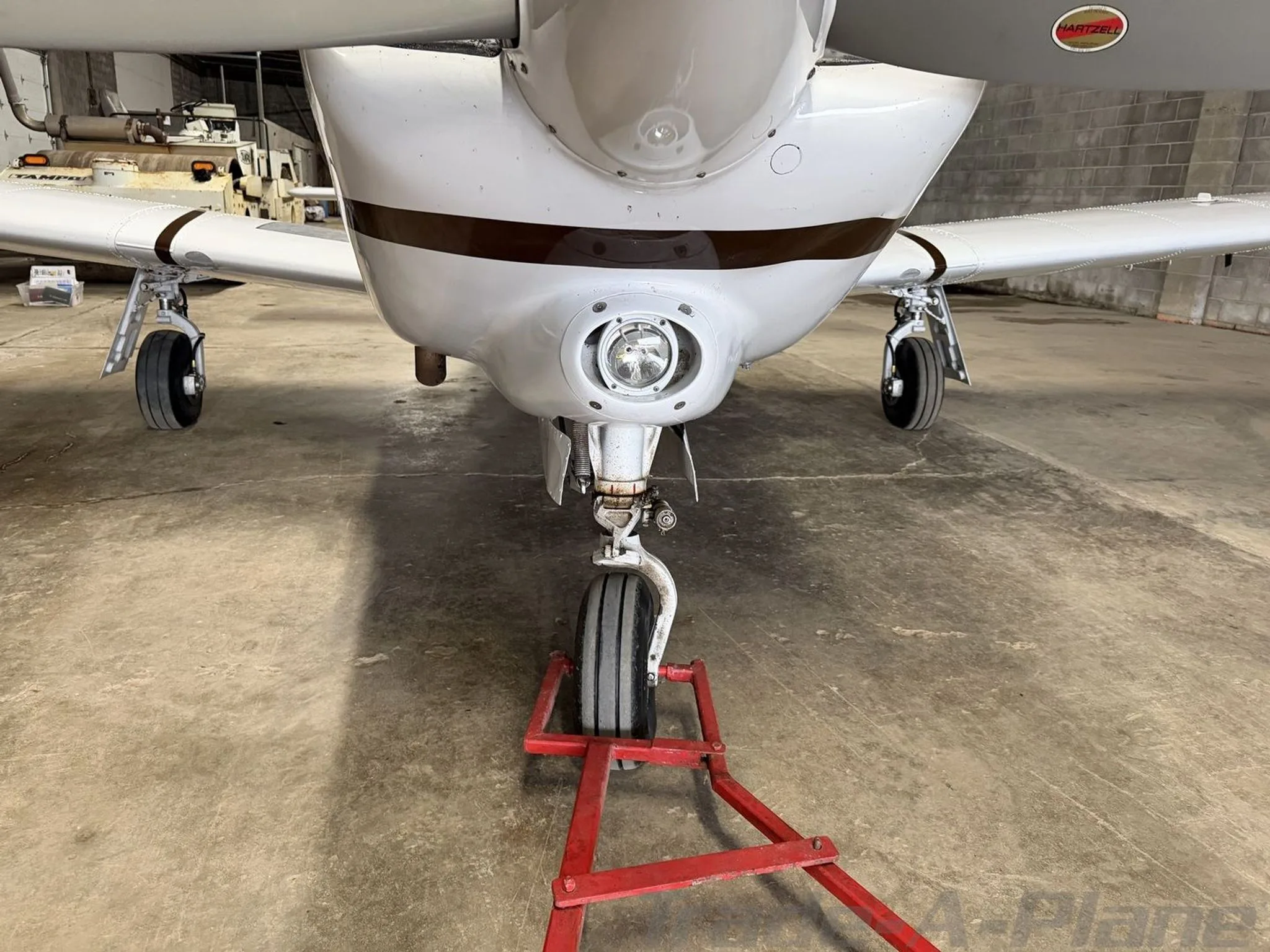 A front view of the landing gear and underside of the white Piper aircraft N41GF.