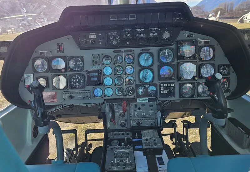 The cockpit of the helicopter features a full instrument panel and dual controls.