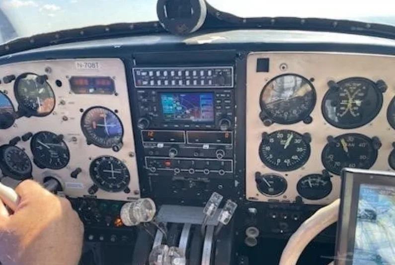 A pilot's view of the aircraft's instrument panel, showing gauges, radios, and controls, with N-708T visible.