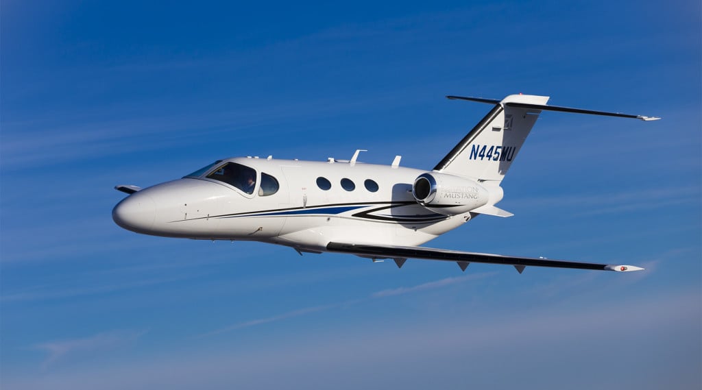 A Cessna Citation Mustang flying in the sky.