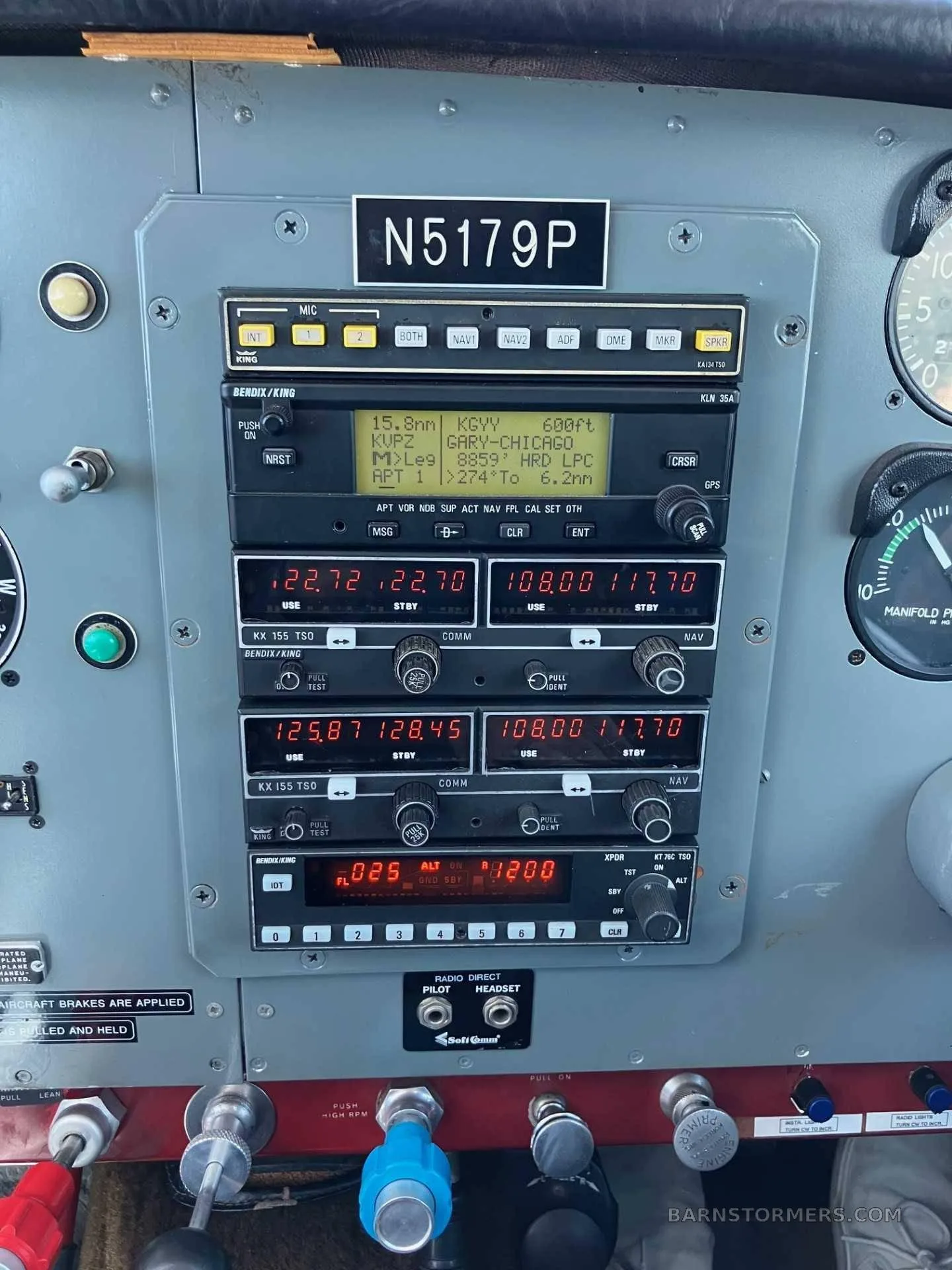 A close-up view of the avionics stack in an aircraft cockpit, showing radios, transponder, and GPS display with registration N5179P.