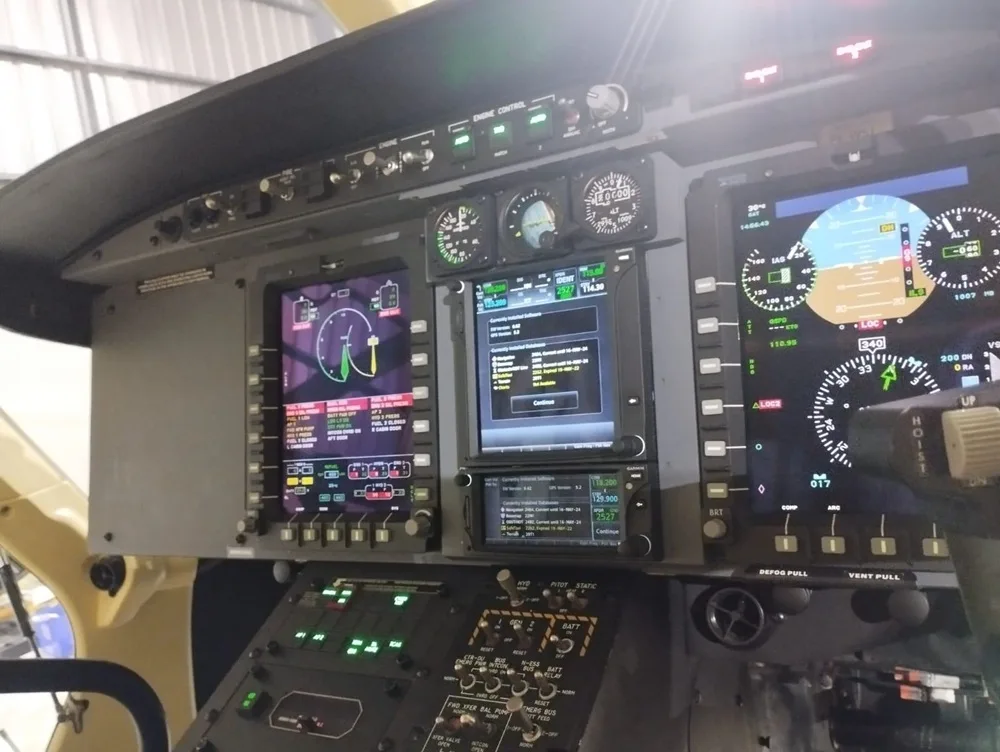 Close-up of the helicopter's instrument panel with multiple displays.