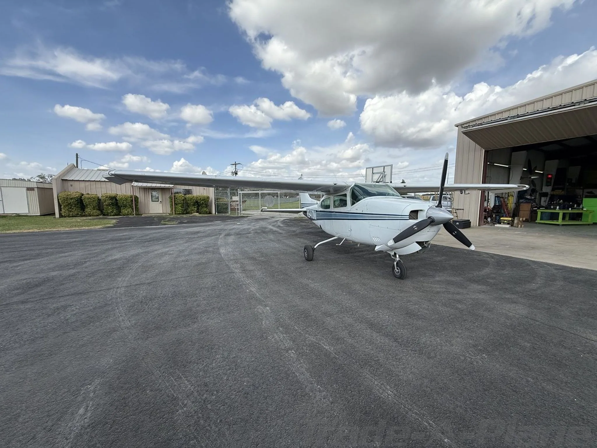 A Cessna 210K parked on the tarmac.