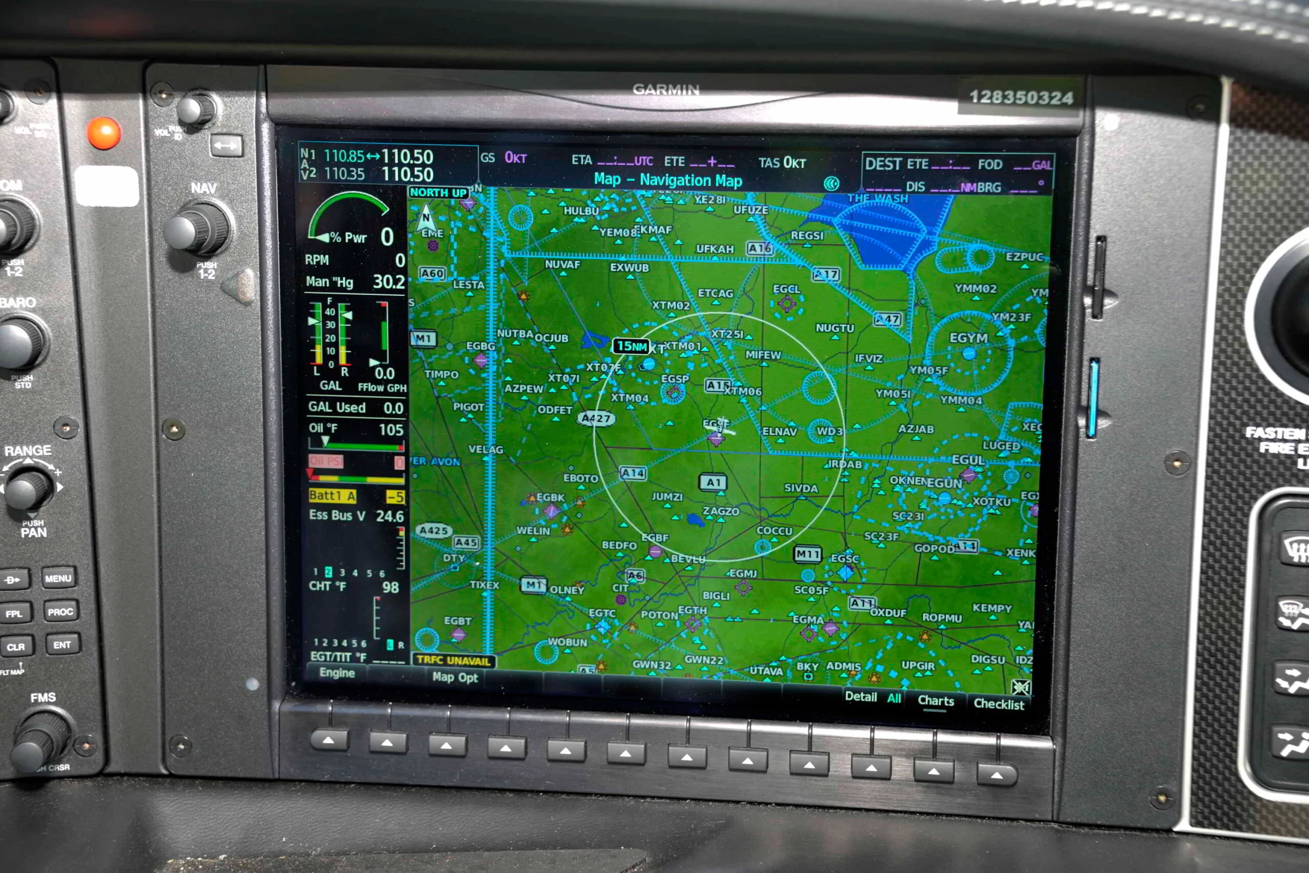 A close-up of a Garmin navigation screen in the cockpit, displaying a detailed map and flight data.