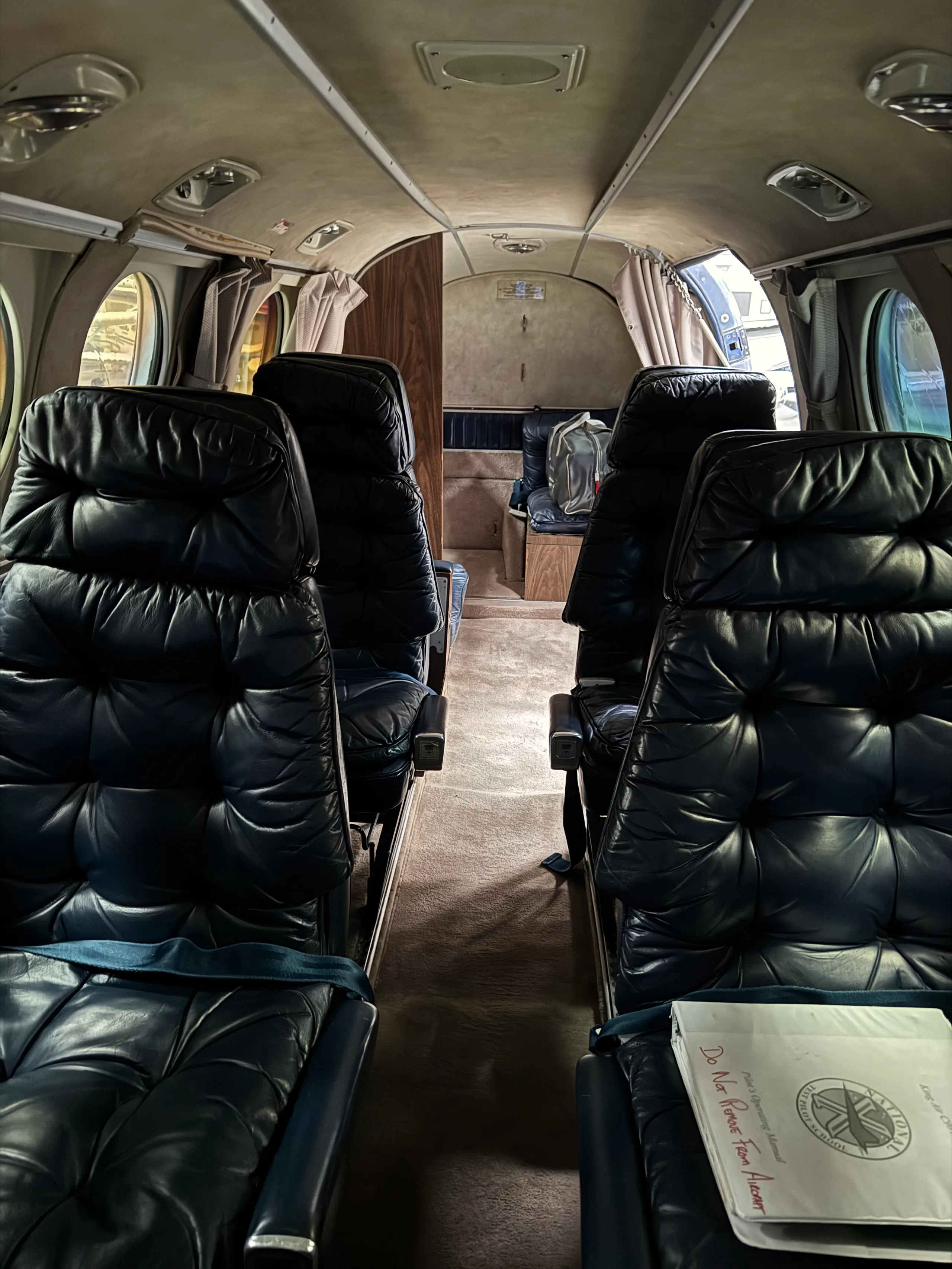 View of the aircraft's interior with black leather seats.