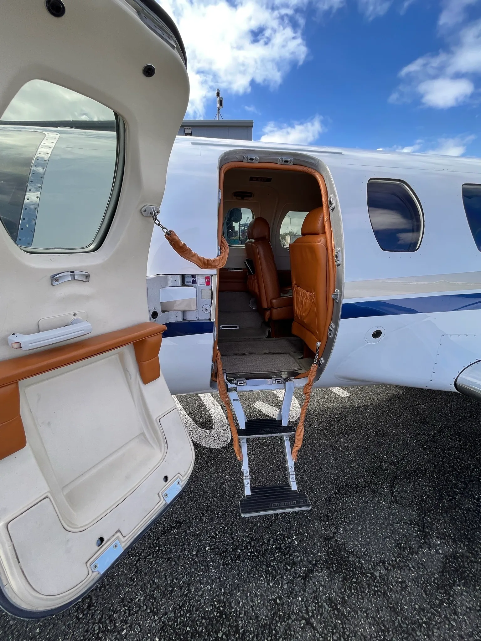 View of the cabin entry door and interior of a Cessna Citation Mustang.