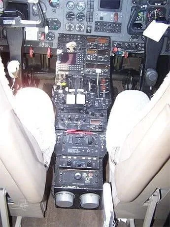 A close-up view of the aircraft's cockpit center console with various controls and instruments.