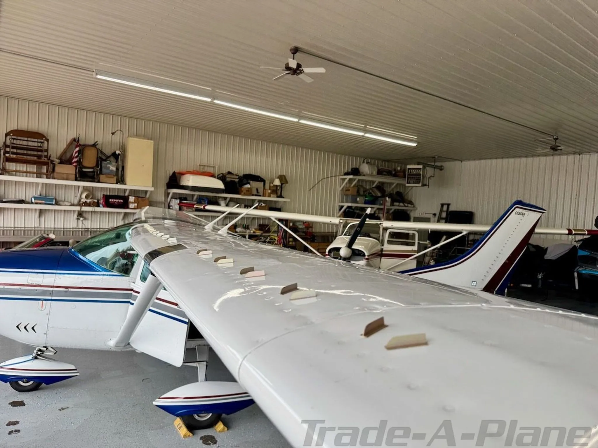 A close-up view of the wing and fuselage of Cessna N2612Q inside a hangar.