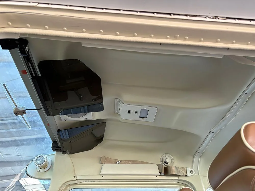 An overhead view of the aircraft cabin ceiling, showing sun visors and an overhead light panel.