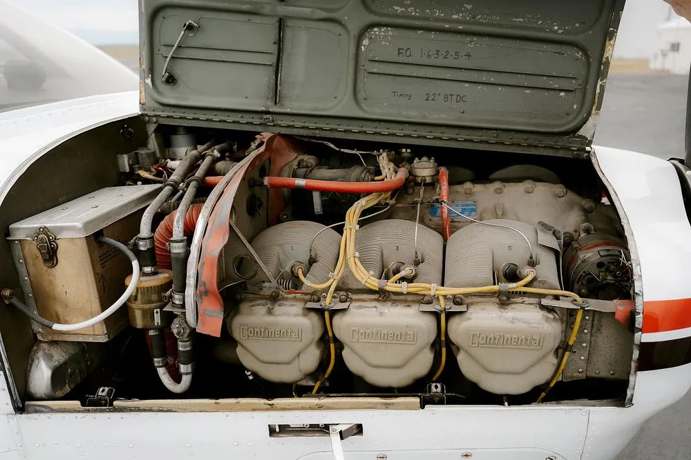 The open engine cowling of a Beechcraft Bonanza aircraft revealing the Continental engine.