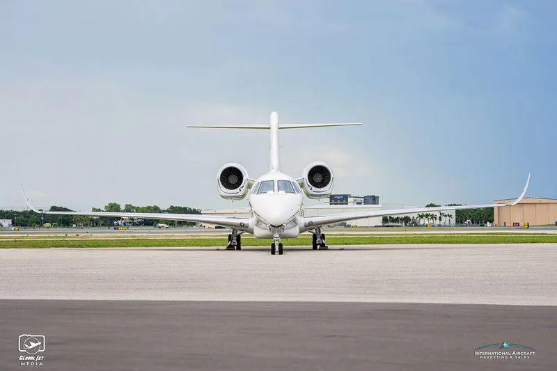 A head-on view of the white Cessna Citation XLS+ business jet N448CX parked on an airfield.