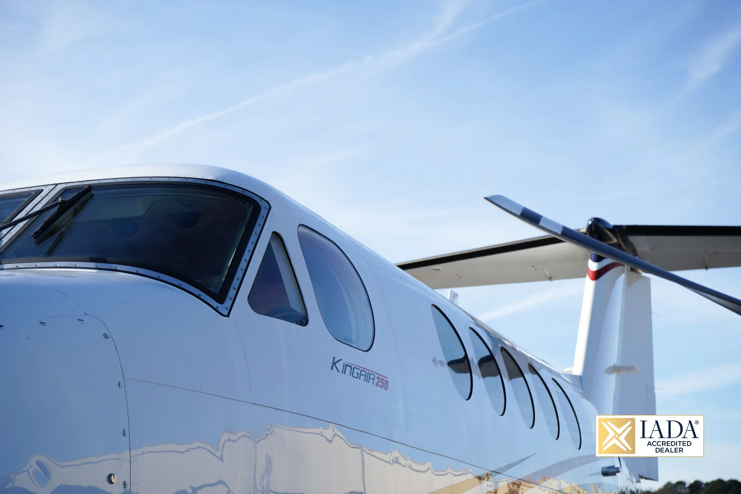 Close up of the side of a Beechcraft King Air 250 showing the windows and tail.