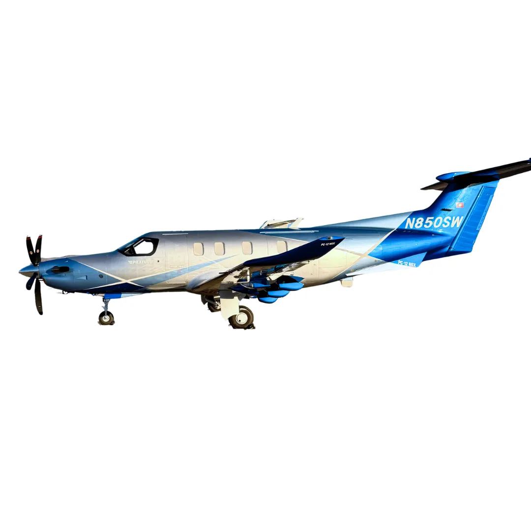 A Pilatus PC-12 NGX turboprop aircraft with a blue and silver paint scheme, viewed from the side against a white background.
