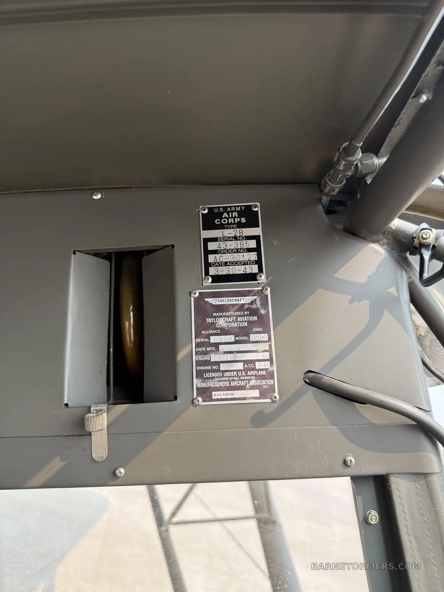 Close-up of the U.S. Army Air Corps and Taylorcraft aircraft identification plates inside the aircraft.