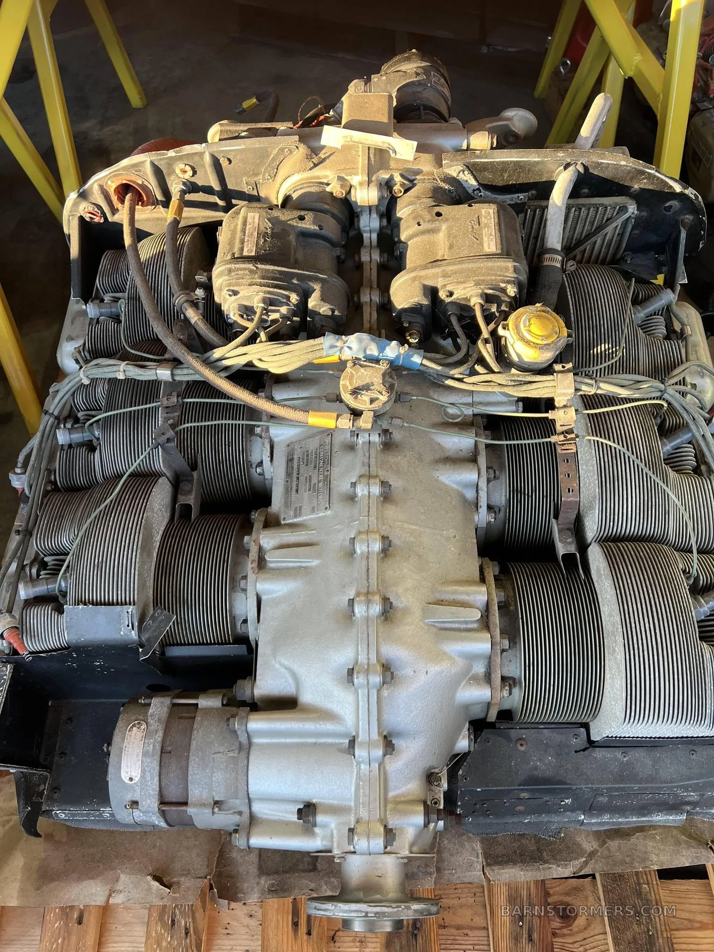 A top-down view of a Teledyne Continental aircraft engine, showing its cylinders and various components.