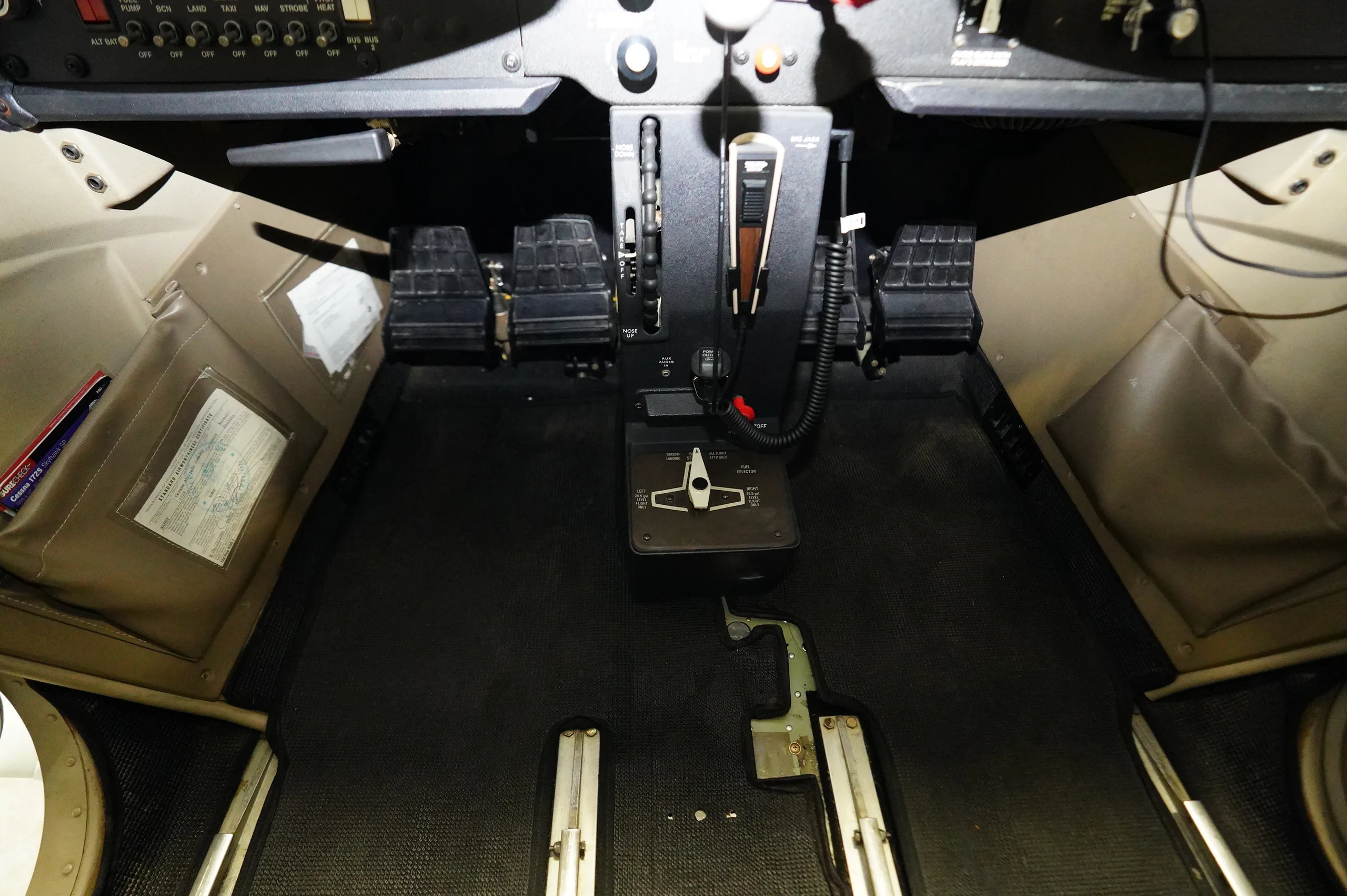 View of the rudder pedals and throttle quadrant in the cockpit of a Cessna aircraft.