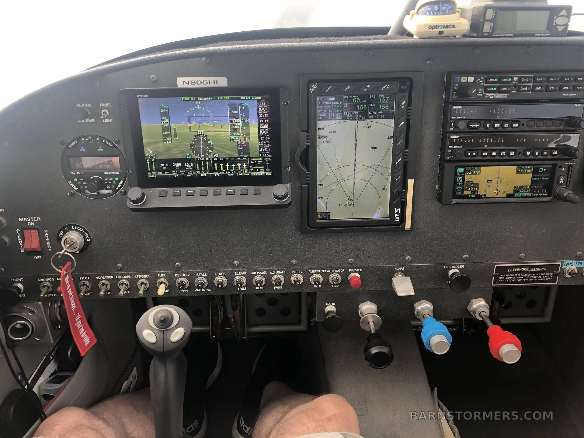 A pilot's view of the aircraft cockpit, showing the instrument panel with digital screens, controls, and the registration N805HL.