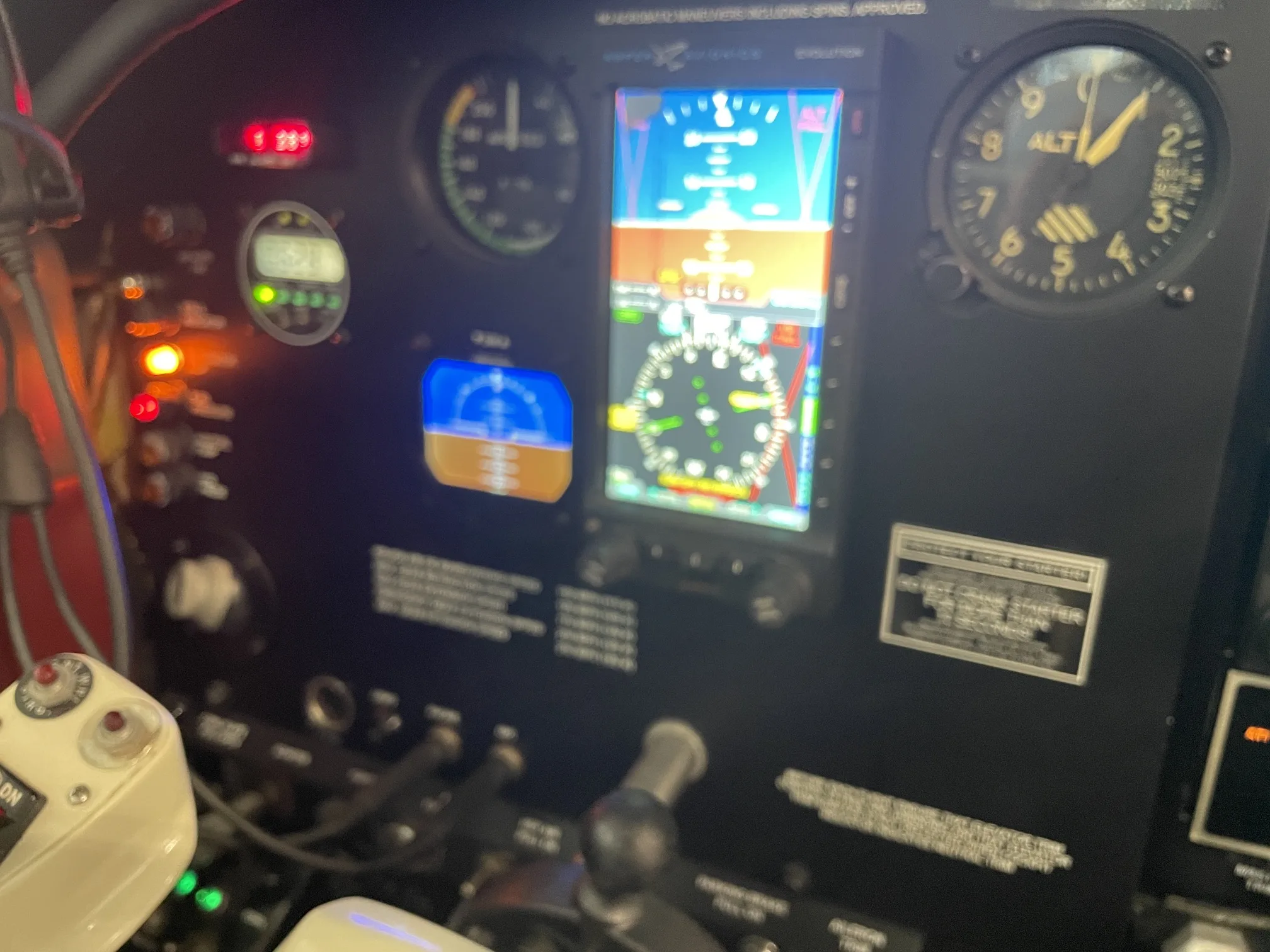 A close-up view of an aircraft's instrument panel, showing analog gauges and digital displays.