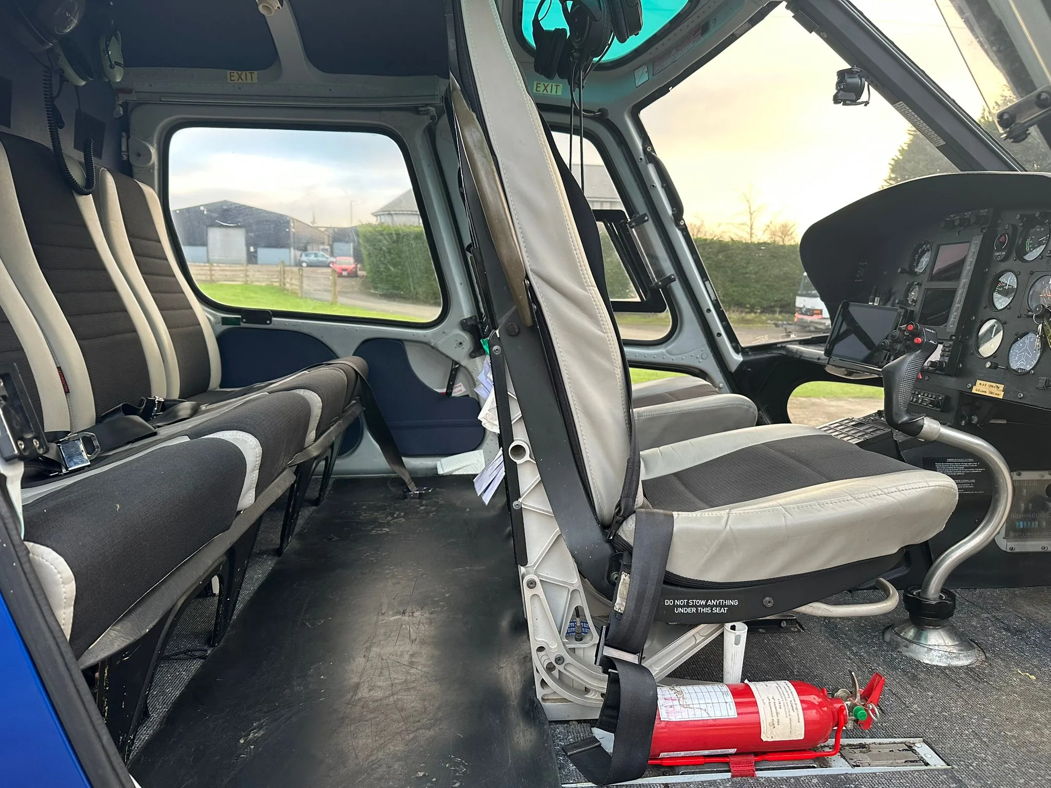 View of the helicopter cabin with seats and cockpit area.