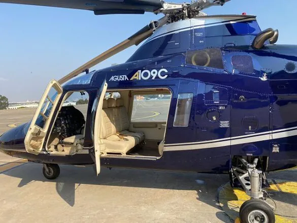 The AGUSTA AW-109 A109C with its door open, showcasing the interior.