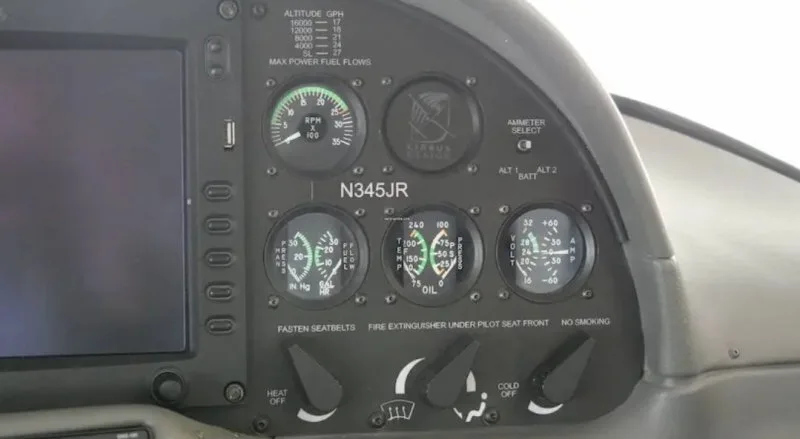 A close-up view of the instrument panel in a Cirrus SR22 cockpit, displaying gauges and controls, including the N345JR registration.