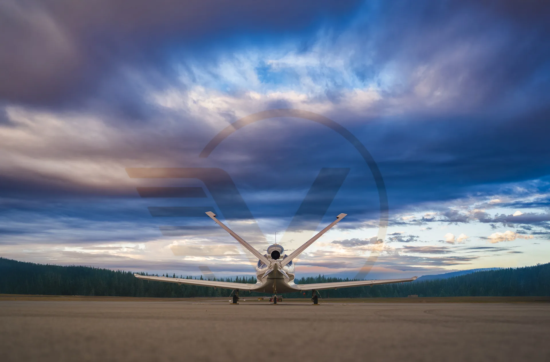 Rear view of Cirrus Vision Jet on the ramp with dramatic sky.