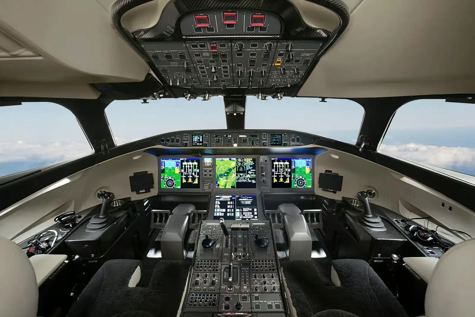The modern, glass cockpit of a Bombardier Global business jet with multiple display screens.