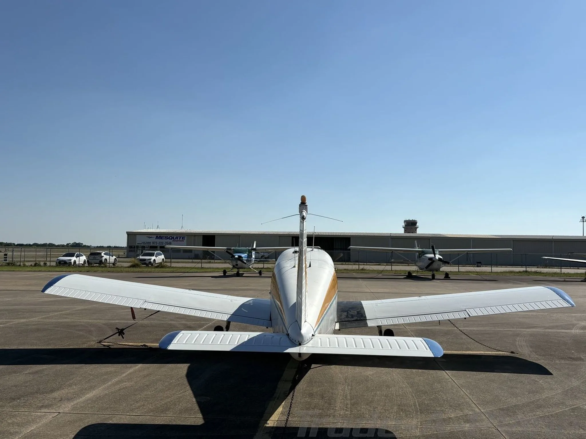 Front view of the aircraft with a hangar in the background.