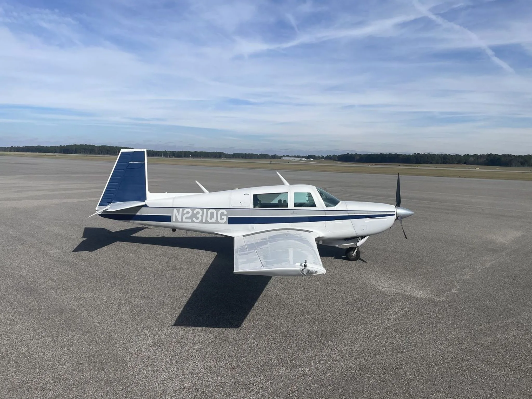A side view of the aircraft on the runway.
