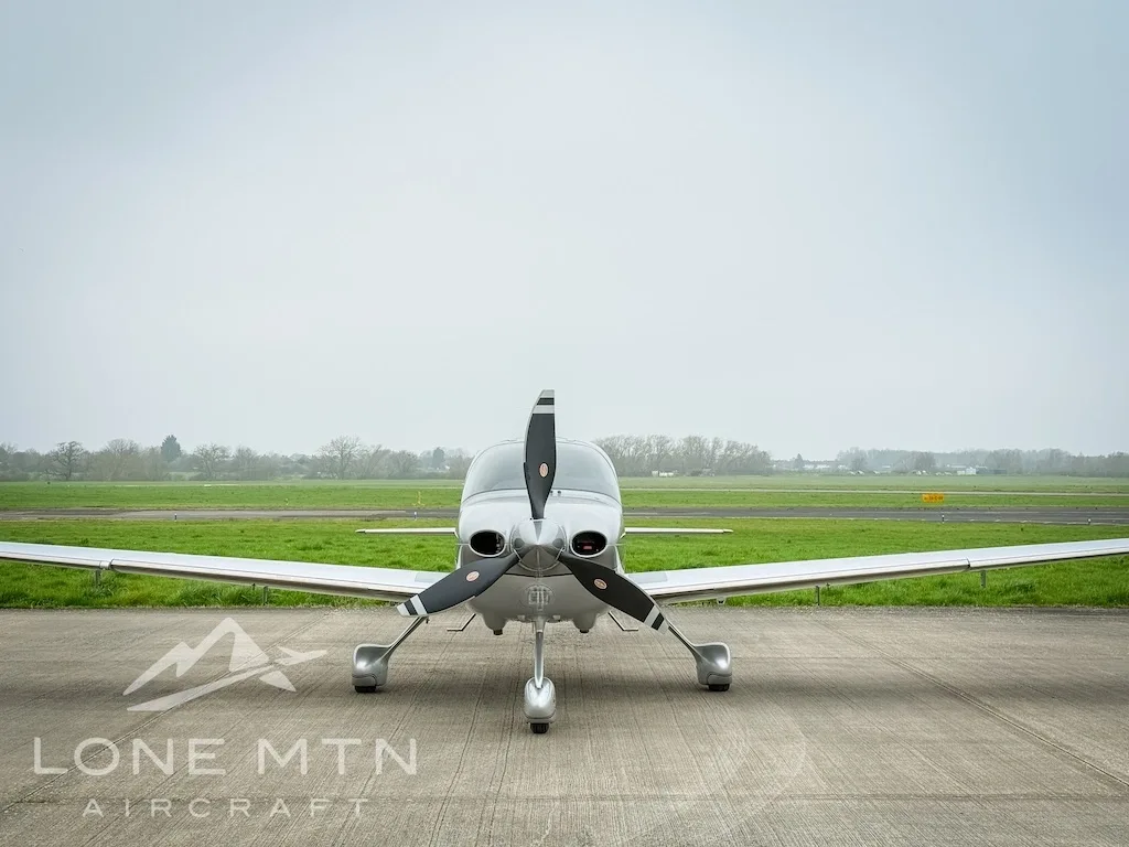 Front view of a silver Cirrus SR22 aircraft, registration N6918C, parked on an airfield.