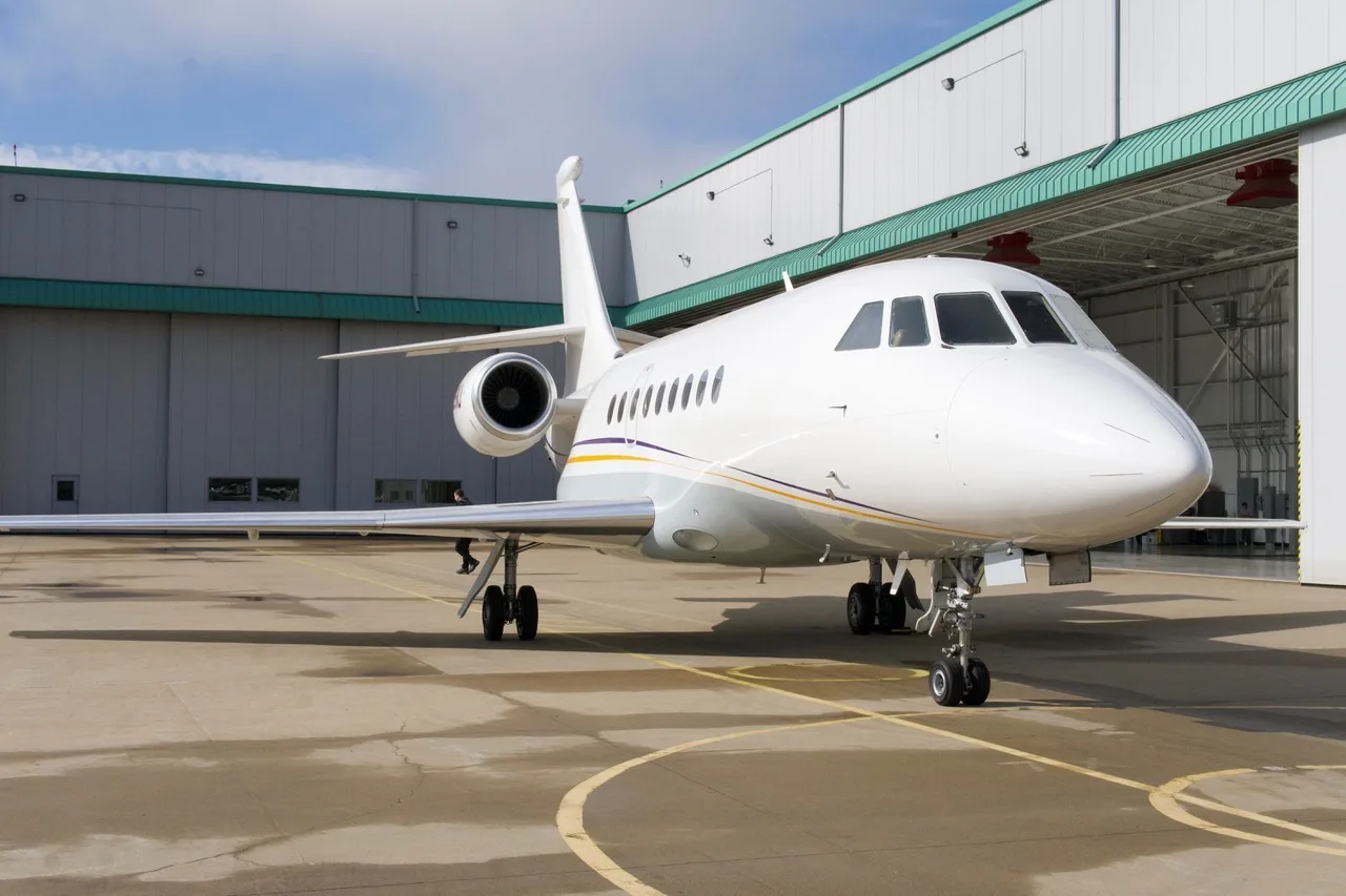 Front view of the aircraft N26NJ parked outside a hangar.
