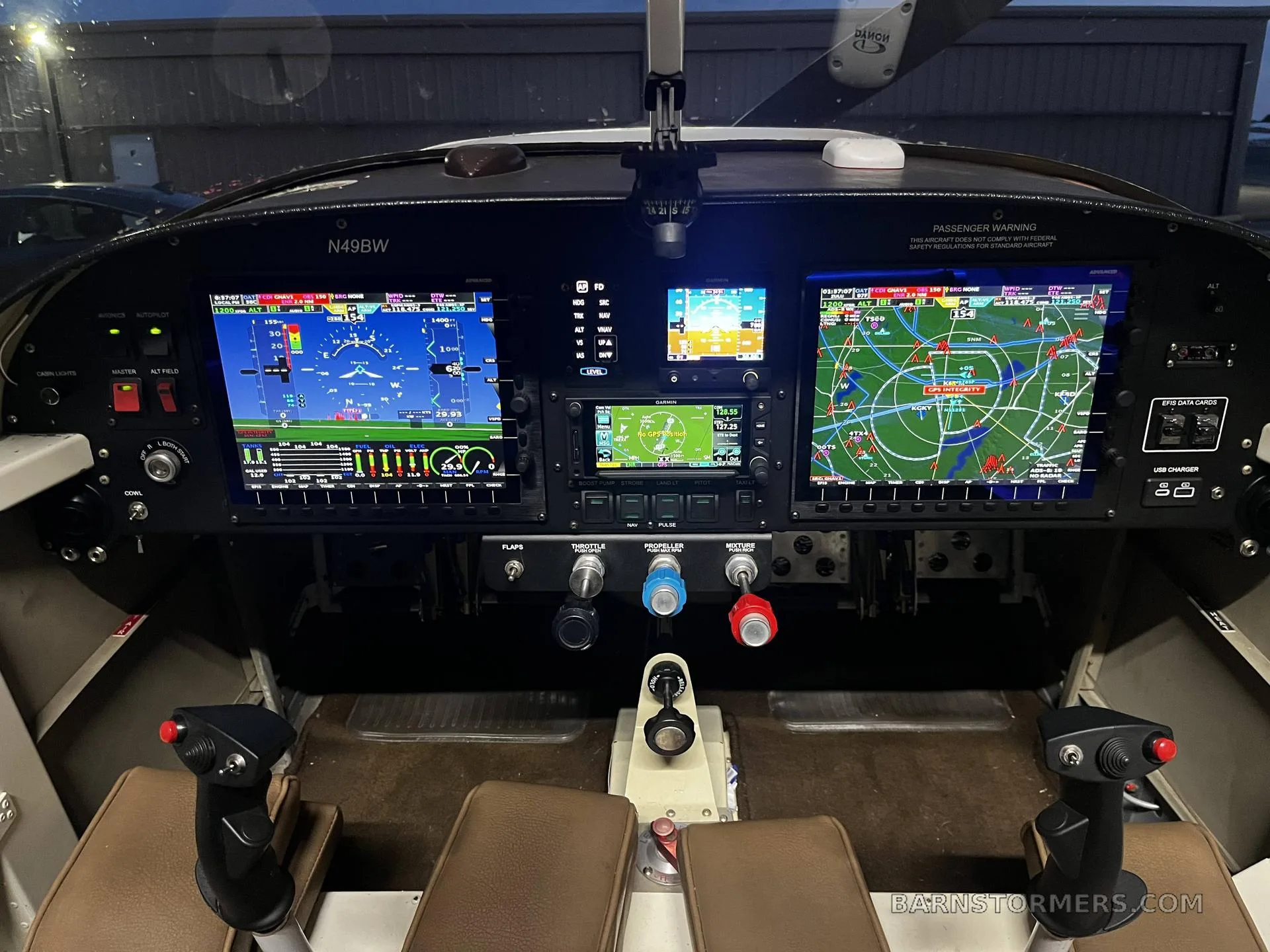 The cockpit of the N49BW experimental aircraft, featuring a modern glass panel with multiple digital displays and flight controls.