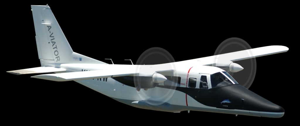 Side view of a white and black twin-engine aircraft against a black background.
