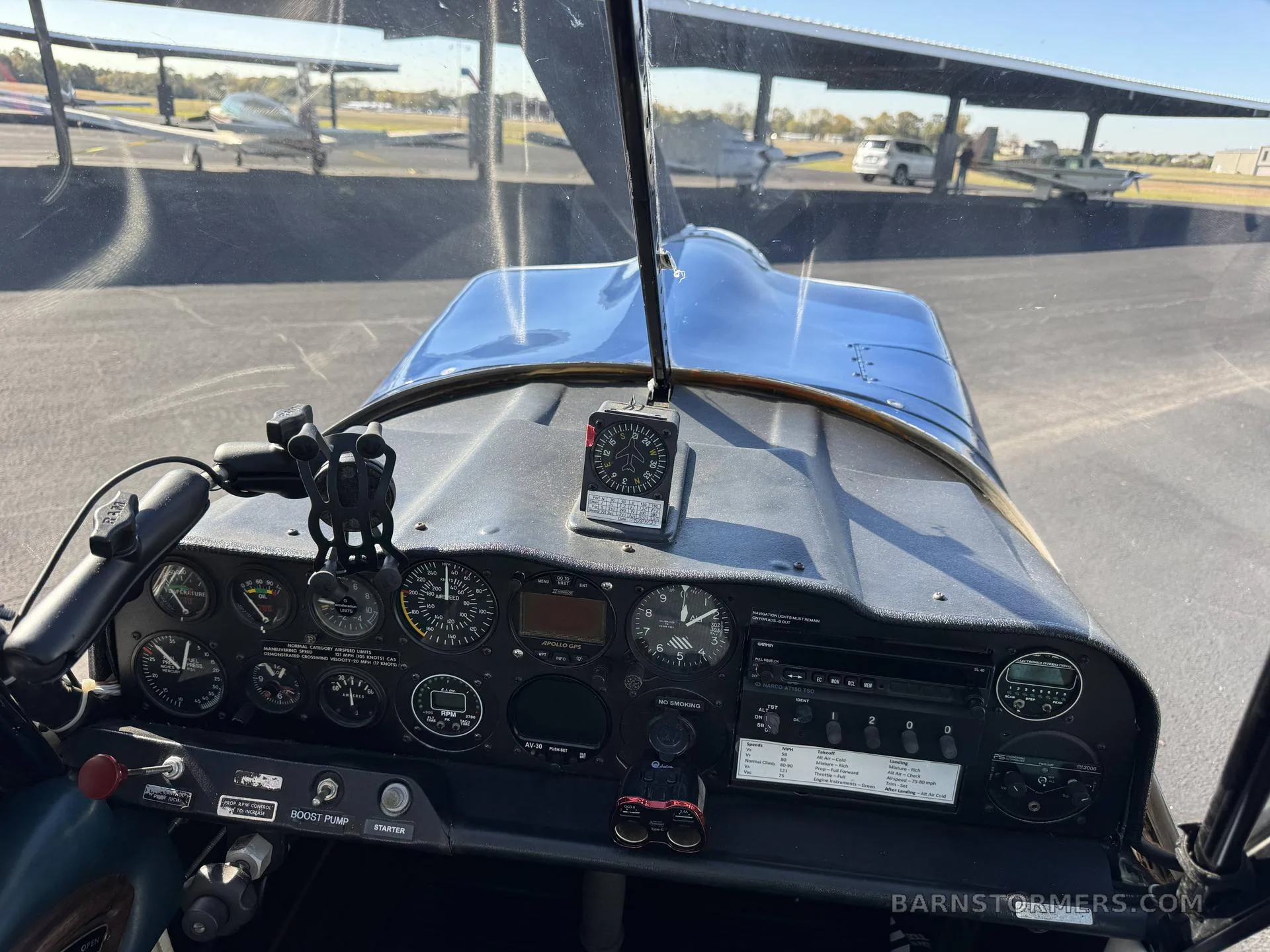A view of the Super Decathlon cockpit from the pilot's seat, looking out over the instrument panel and nose.