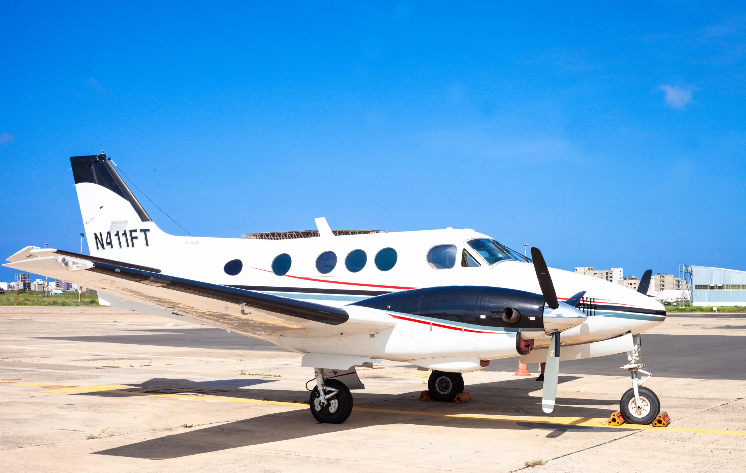A King Air N411FT is parked on the tarmac.