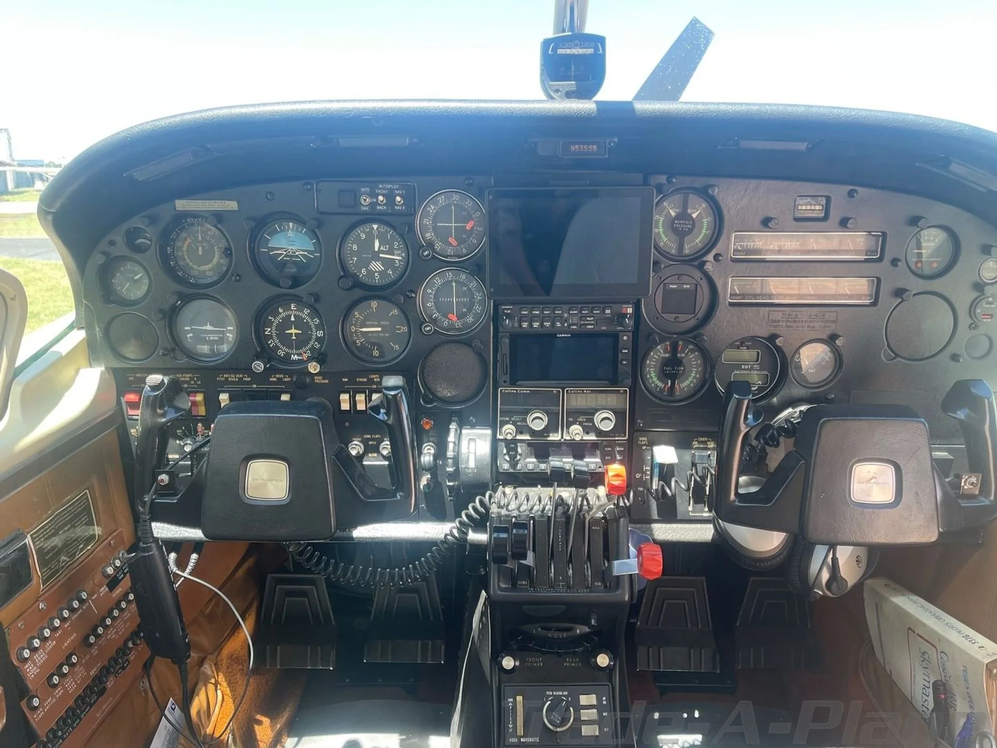 A full view of the Cessna 206 cockpit, featuring the instrument panel, yokes, and avionics.