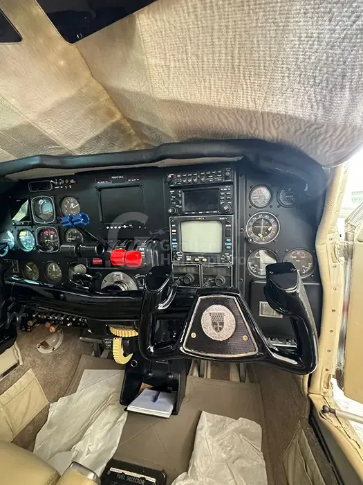 A view of the right side of the aircraft cockpit, showing the instrument panel, controls, and floor area.