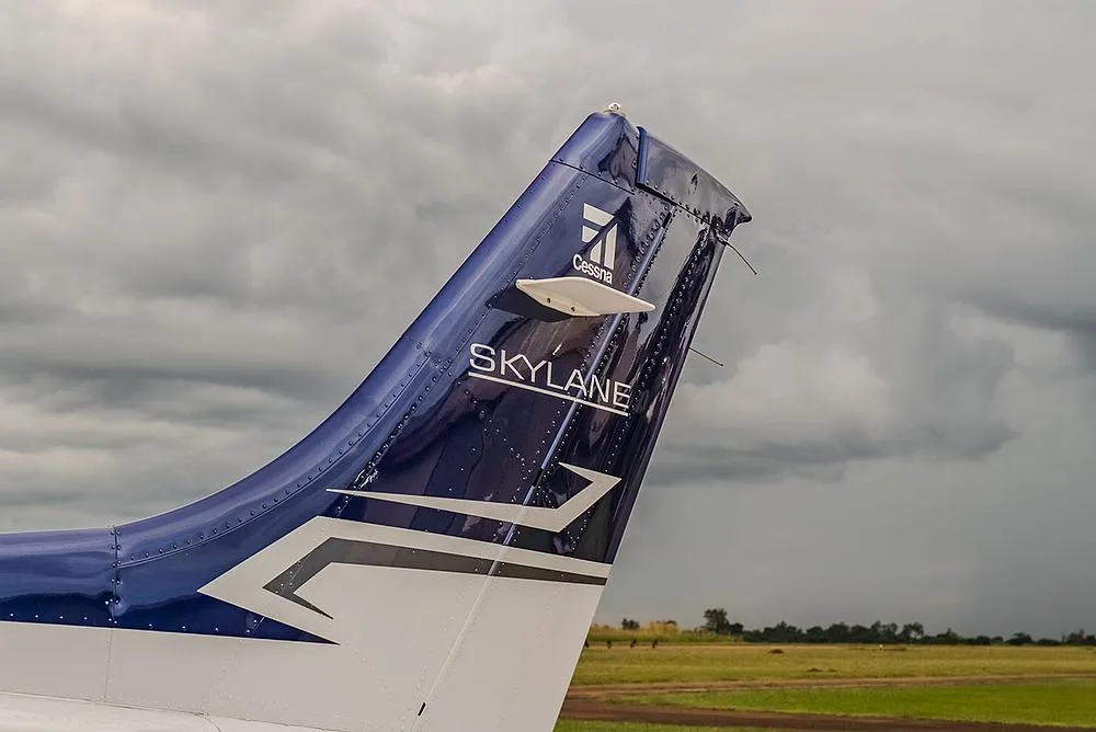 A close-up of the blue and white tail of a Cessna Skylane, showing the logo and model name.