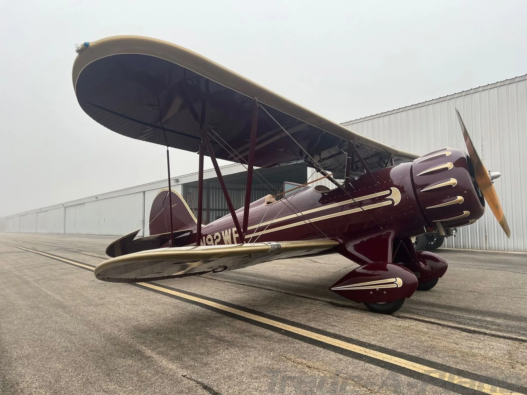 A WACO YMF-5C in a foggy environment.