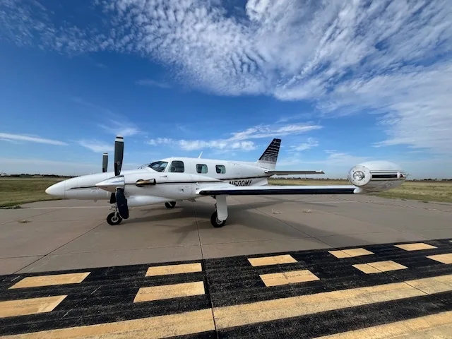 A side view of the 1978 Piper Cheyenne I on the runway.