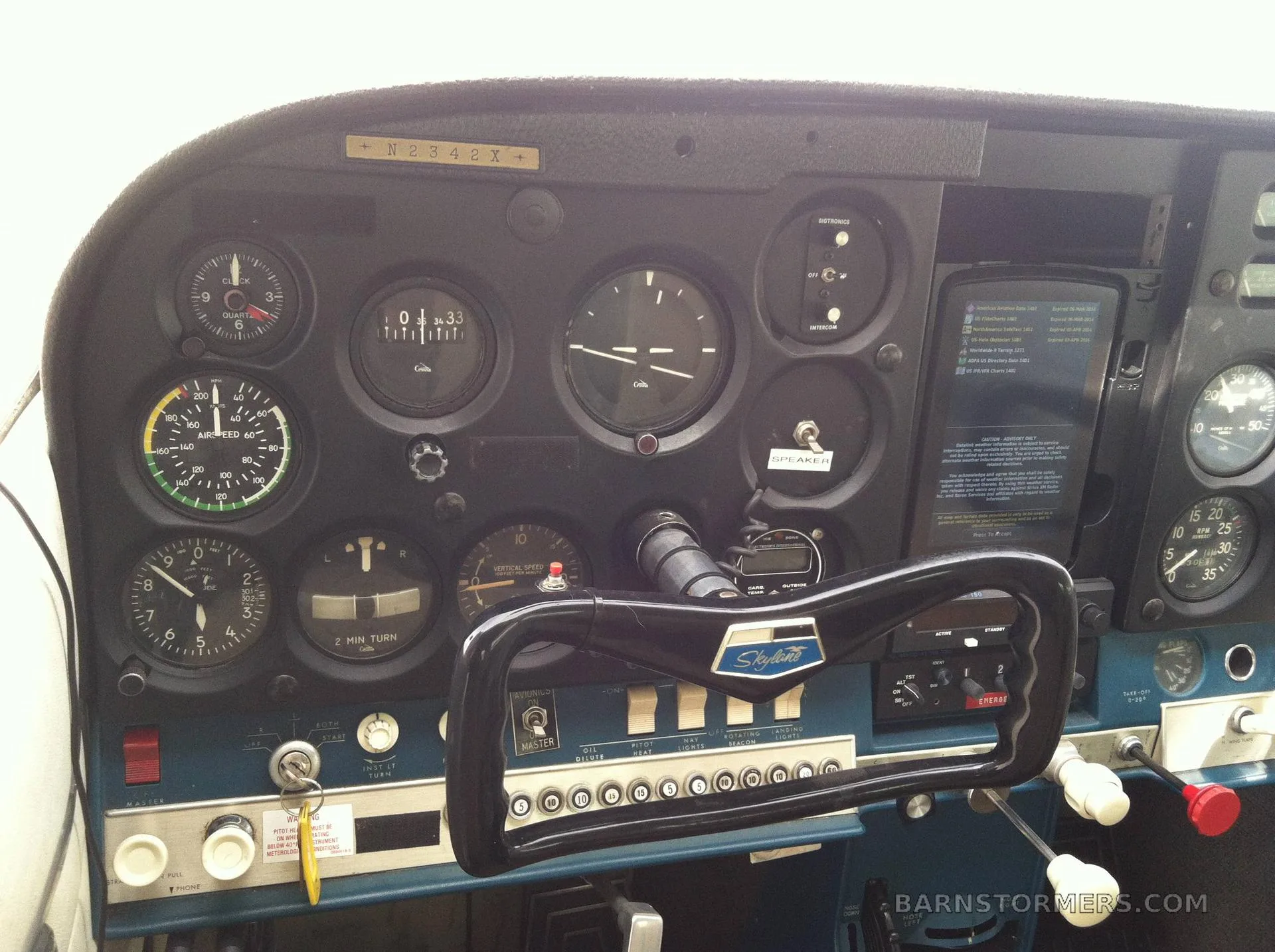 A close-up view of the instrument panel of a Cessna 182 Skylane, showing various gauges and controls.