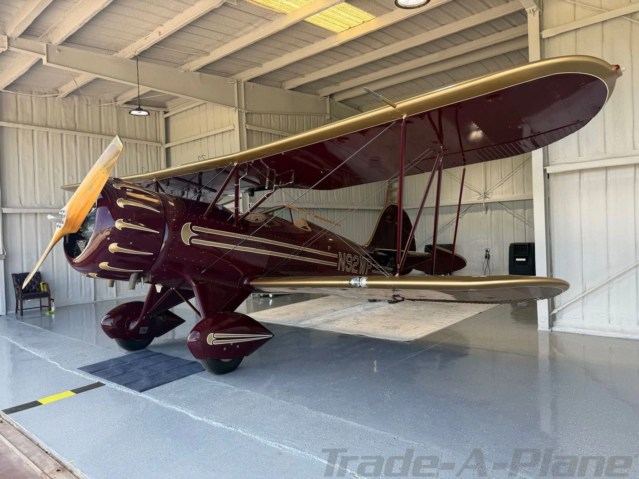 A WACO YMF-5C displayed in a hangar.